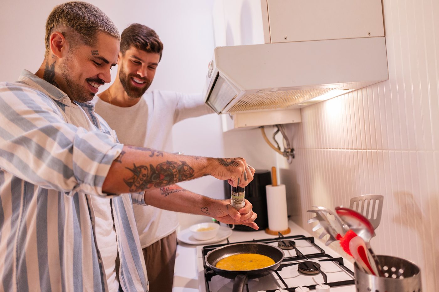 Two Gaydar members cooking together at home